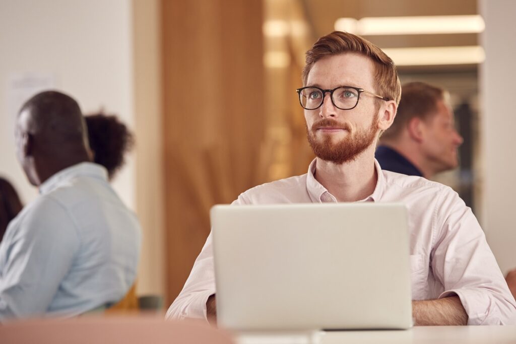 Businessman With Laptop Working On Table In Office Coffee Shop